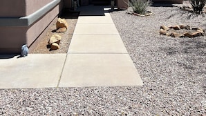 A house with a concrete driveway, a front door, and a small porch area. - Desert Oasis Retreat (Rio Rico)