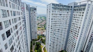 A high-rise residential building with multiple balconies and a central courtyard. - Nice And Comfort 2Br Apartment At 30Th Floor M-Town Residence (Gading Serpong)