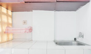 Studio | Private kitchen | Fridge, stovetop, electric kettle, rice cooker - Compact Studio At Margonda Residence 1 Apartment (Depok)