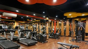 A gym with treadmills, elliptical machines, and weight machines. - Comfortable 1Br At Signature Park Grande Near Cawang Station Apartment (Jakarta)