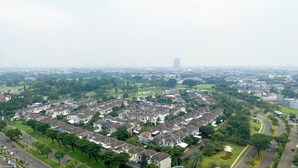 A residential area with houses, roads, and greenery.