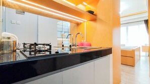 A modern kitchen with a black countertop, stainless steel appliances, and a sink.