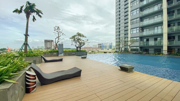 A rooftop pool area with lounge chairs and a view of a cityscape. - Best Choice And Comfy 2Br Daan Mogot City Apartment (Jakarta)