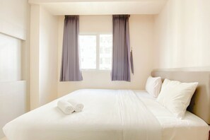 Relax in comfort with a large bed and plush linens.