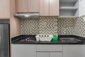 Studio | Private kitchen | Full-sized fridge, stovetop, electric kettle - Modern Look And Homey Studio Apartment Amazana Serpong (South Tangerang)