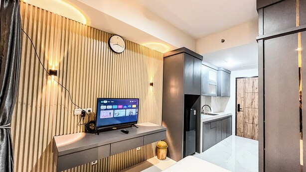 A modern bathroom with a built-in sink, a mirror, and a towel on the counter.