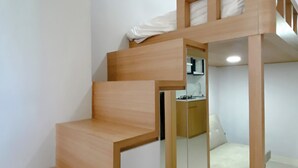 A bunk bed with a small enclosed space underneath, a mirror, and a white mattress. - Restful And Well Designed Studio Transpark Juanda Bekasi Timur Apartment (Bekasi)