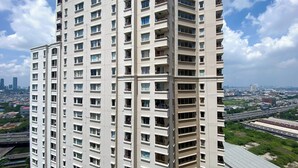 A high-rise building with multiple balconies and a view of the cityscape in the background. - Best Deal And Restful 2Br Marina Ancol Apartment (Jakarta)