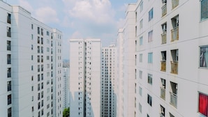 A high-rise residential building with multiple balconies and windows.