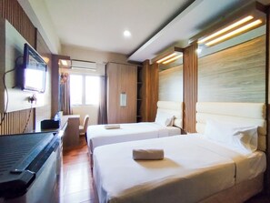 Relax in a stylish room with a large bed, flat-screen TV, and desk area.