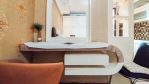 A bathroom with a white sink, a mirror, a towel rack, and a shower area. - Nice And Comfortable Stay Studio At Gateway Ahmad Yani Cicadas Apartment (Bandung)