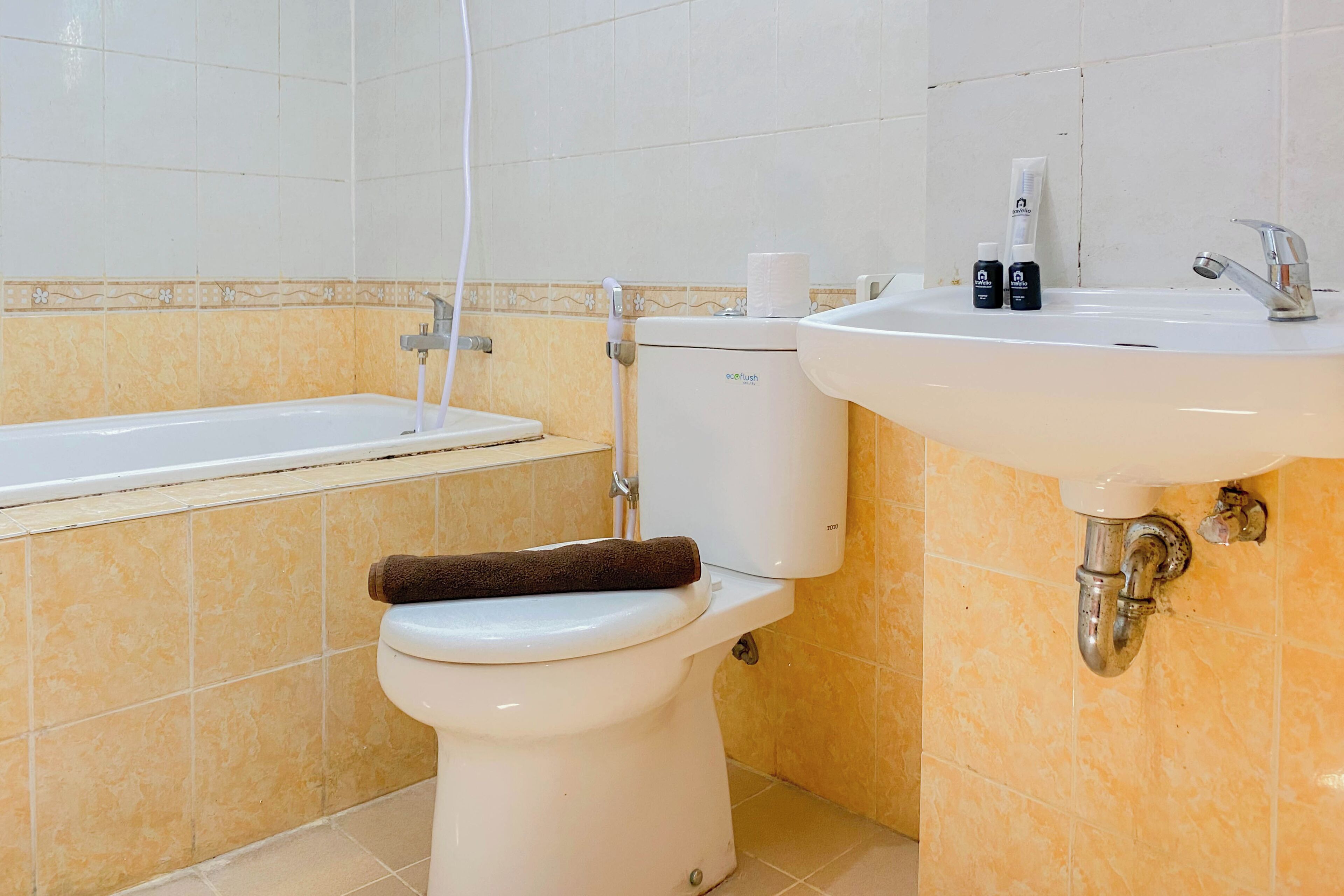 A bathroom with a toilet, a bathtub, and a sink.