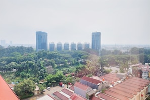 A cityscape with modern high-rise buildings and a mix of residential and commercial buildings.
