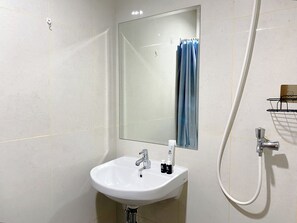 Studio | Bathroom | Shower, towels, soap, shampoo - Homey and Minimalist Studio LRT City Jatibening Apartment (Bekasi)