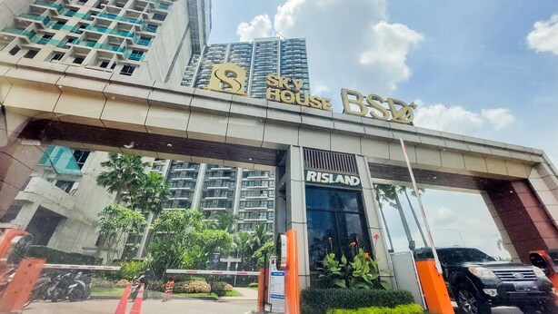 A hotel entrance with a large sign reading "Sky House B&Q". - Comfort Living 2Br At Sky House Bsd Apartment (Pagedangan)