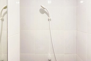 Studio | Bathroom | Shower, towels, soap, shampoo - Good And Homey Studio Tokyo Riverside Pik 2 Apartment (Teluknaga)