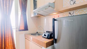 A kitchen with a stainless steel refrigerator, a toaster, and a sink. - Good Deal And Homey Studio At Margonda Residence 4 Apartment (Depok)