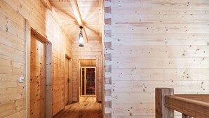 A wooden interior with a hallway leading to a door. - Glockner by Interhome (Heiligenblut)