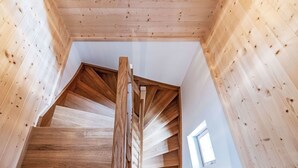 A wooden staircase leading to a loft bedroom with a skylight. - Glockner by Interhome (Heiligenblut)
