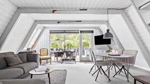 A modern loft bedroom with a sloped ceiling, large windows, and a balcony. - Nice home in Farsø with kitchen (Farsø)