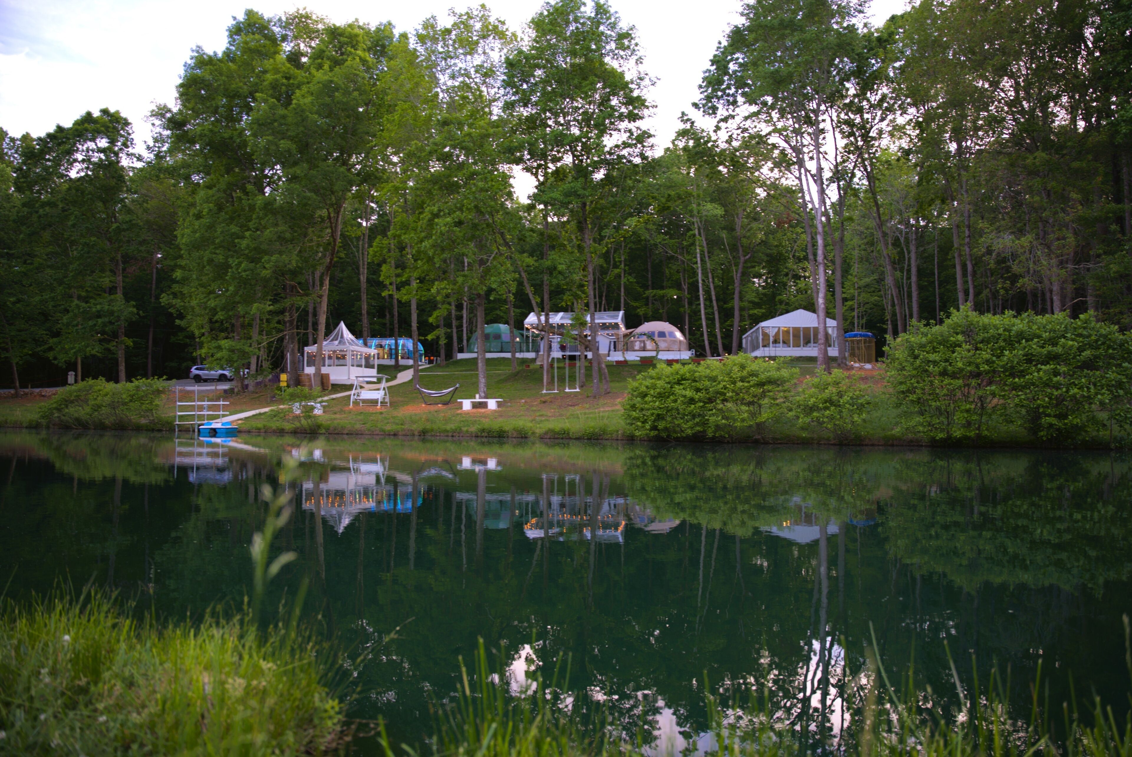A lakeside property with multiple cabins and a dock.