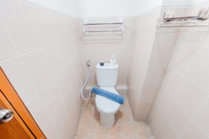A small, clean bathroom with a toilet, a towel rack, and a toilet paper holder. - Good Price And Homey 2Br At Loftvilles City Apartment (South Tangerang)