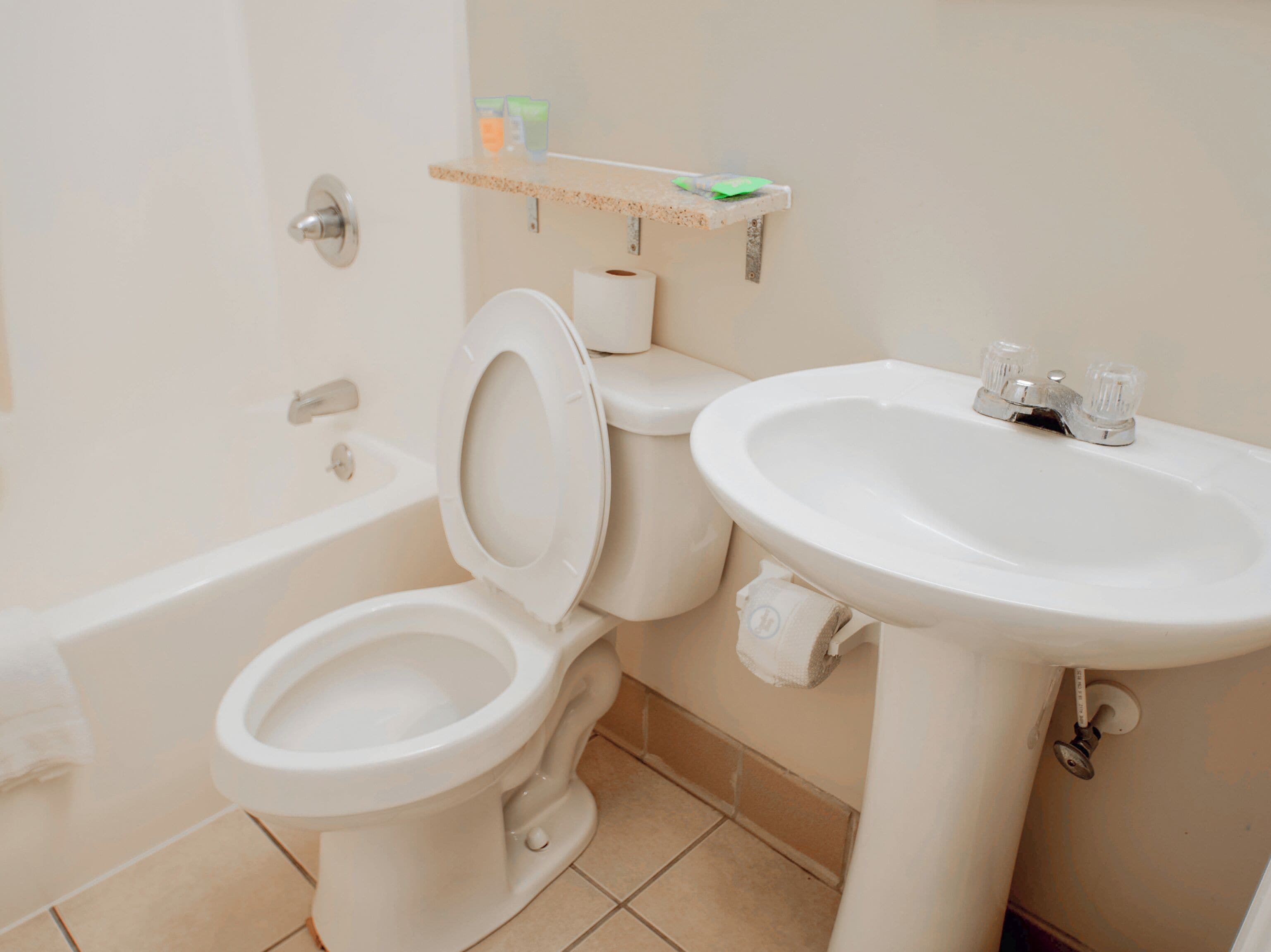 A bathroom with a toilet, bidet, and sink.