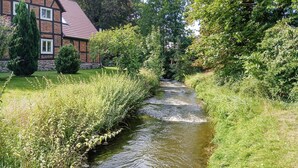 A narrow water channel flanked by lush greenery and a traditional half-timbered building. - 2 bedroom awesome home in Dobbin (Dobbin)