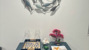 A blue cabinet with a decorative fish wall art piece above it.