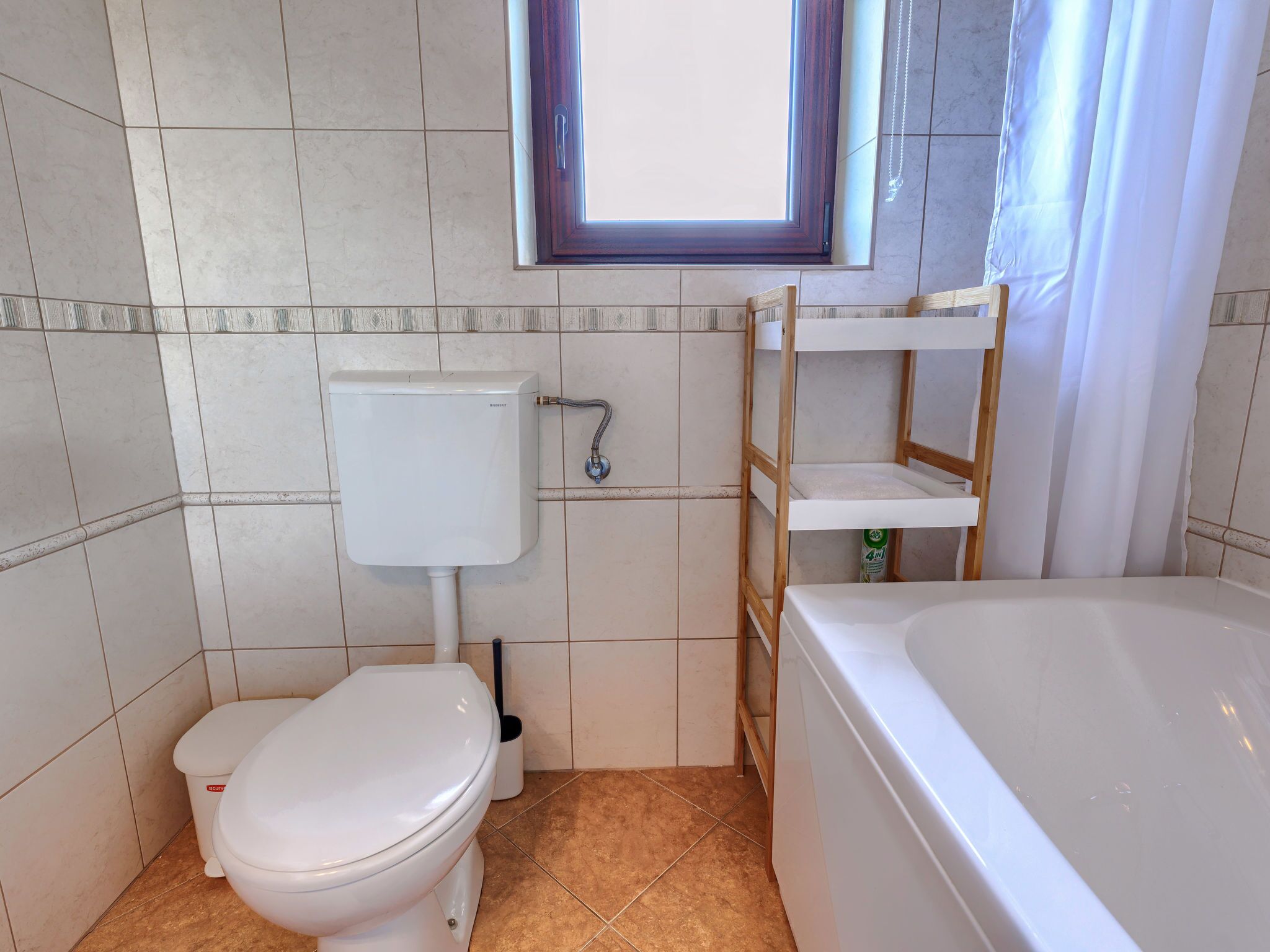 A bathroom with a toilet, a sink, and a bathtub.