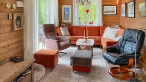 A cozy living room with a sofa, chairs, a coffee table, and a fireplace. - 3 bedroom lovely home in Sandnes (Sandnes)