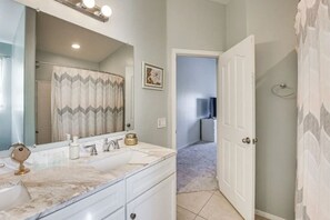 A bathroom with a large mirror, two sinks, and a shower area. - Mesa Oasis | Patio | Spacious | Central | Garage (Mesa)