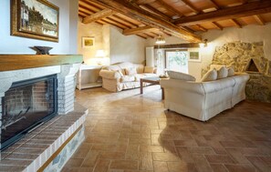 Cozy living room with a fireplace, comfortable seating area, and rustic charm.