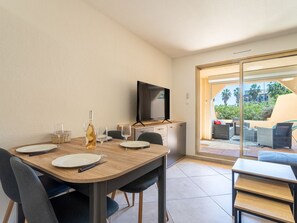 Enjoy a romantic dinner for two in this stylish dining area with a flat-screen TV and sliding glass door to the outdoor patio.