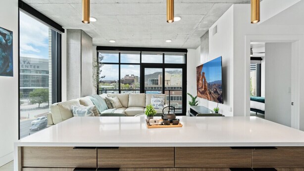 A modern kitchen with a large island, built-in cabinets, and pendant lighting. - 2bd/2ba Best style and location/Pool+spa/gym/pkg! (Salt Lake City)