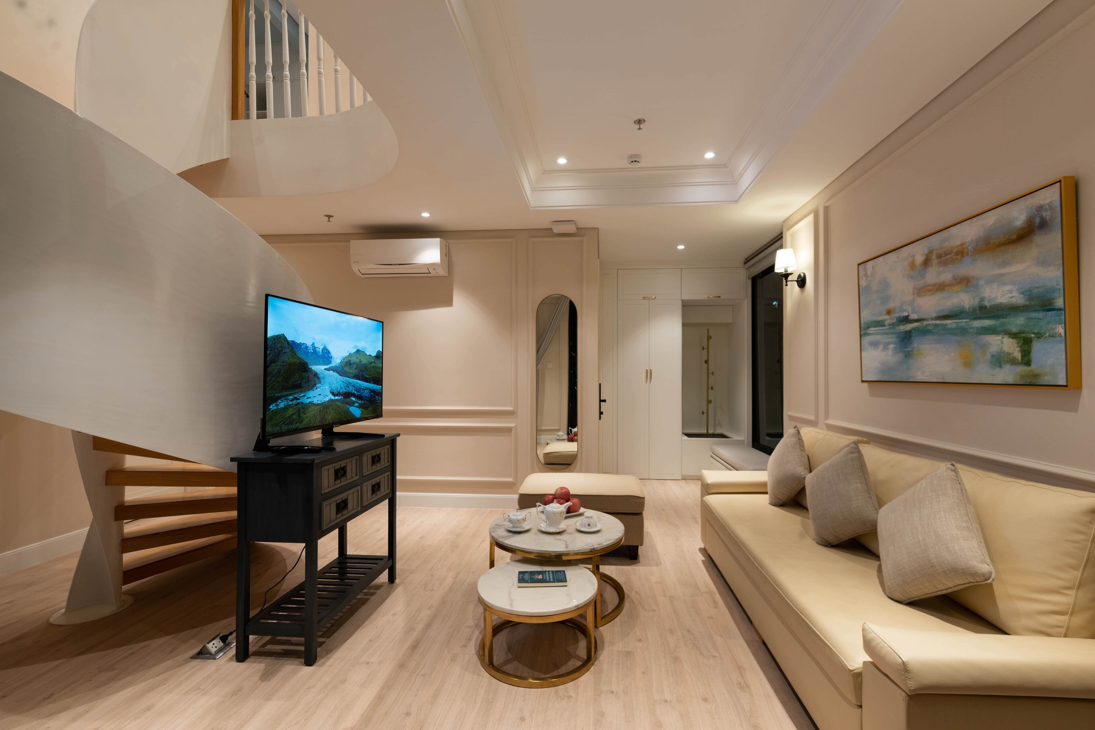 A modern living room with a TV, sofa, and coffee table.