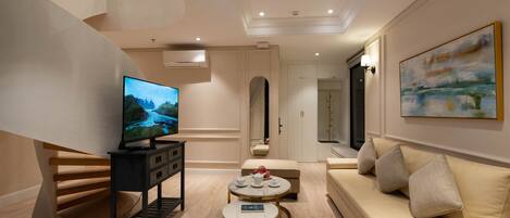 A modern living room with a TV, sofa, and coffee table.