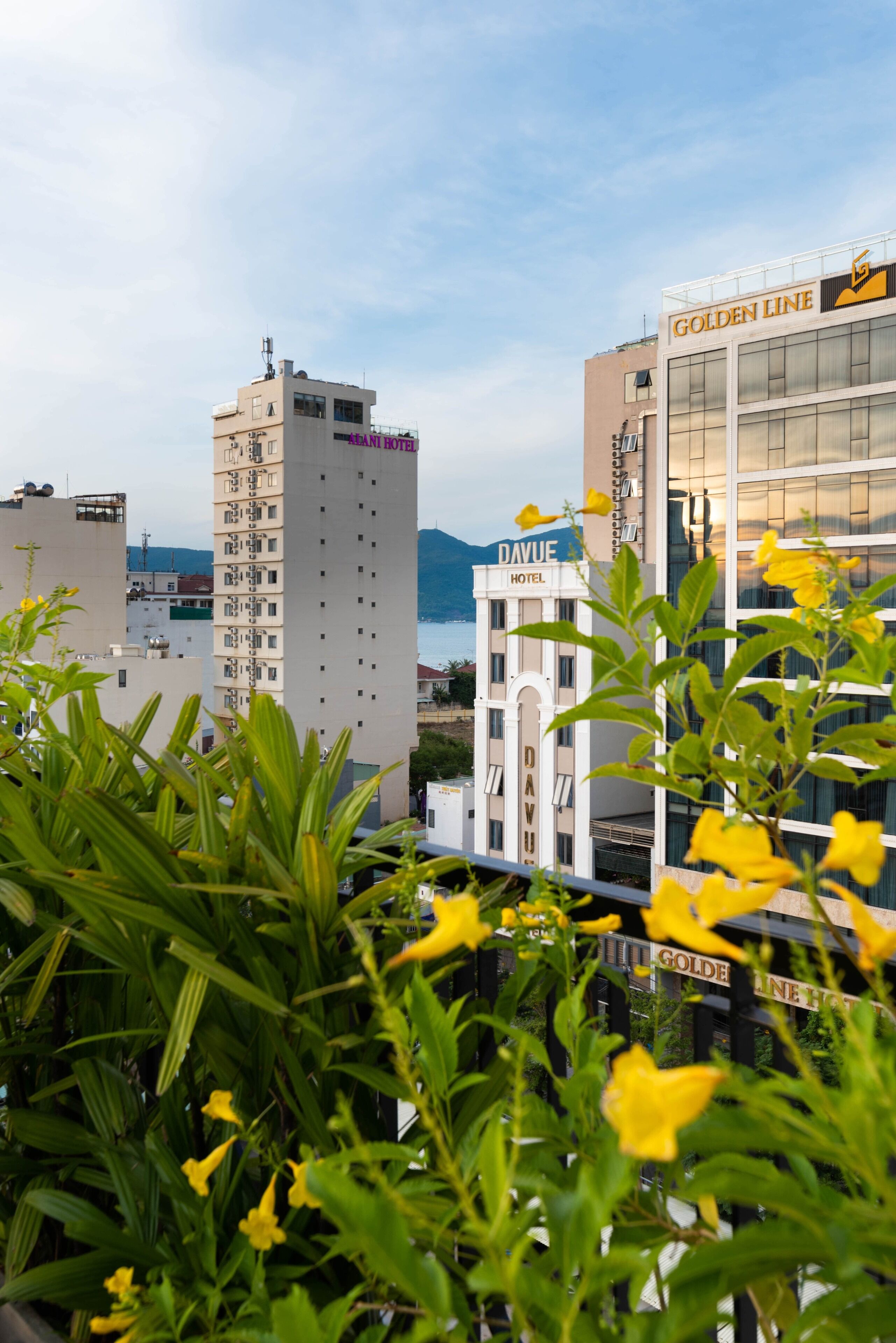A hotel named 'Golden Line Hotel' with a view of the sea and mountains in the background.
