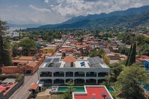 A town with a prominent building featuring a central courtyard and a swimming pool. - Tranquil Studio Suite with Outdoor Salt Water Pool (Ajijic)