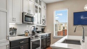 Fridge, microwave, oven, stovetop - Reluxme | Uptown 3BR w/ King Beds & Spa Access (Charlotte)