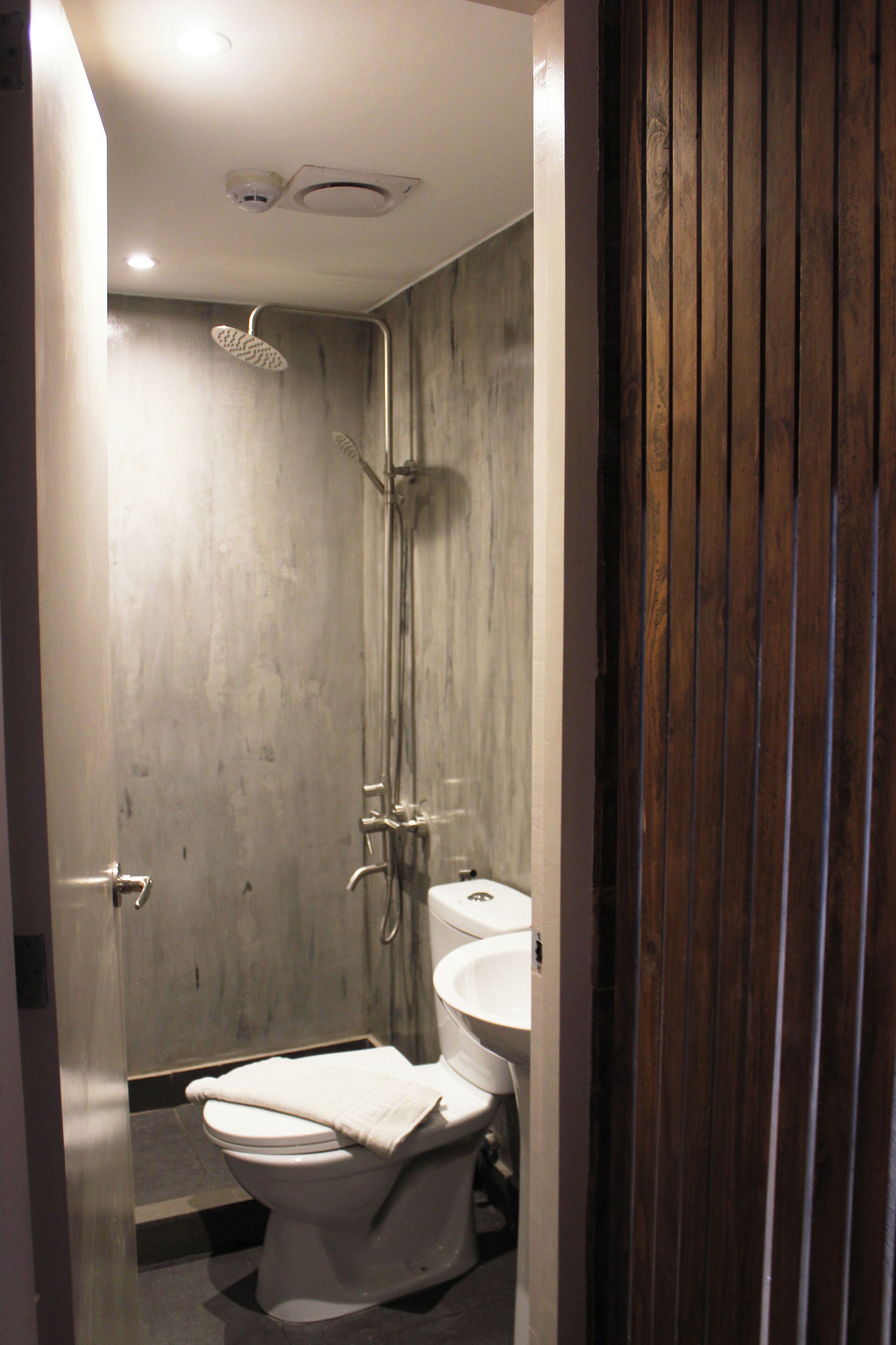 A bathroom with a shower, toilet, and sink.