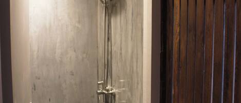 A bathroom with a shower, toilet, and sink.