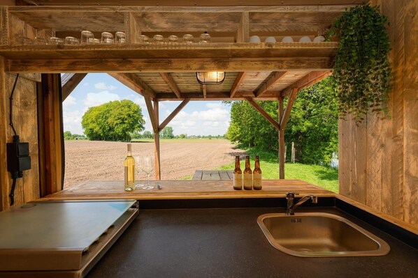 Fridge, stovetop, dishwasher, coffee/tea maker