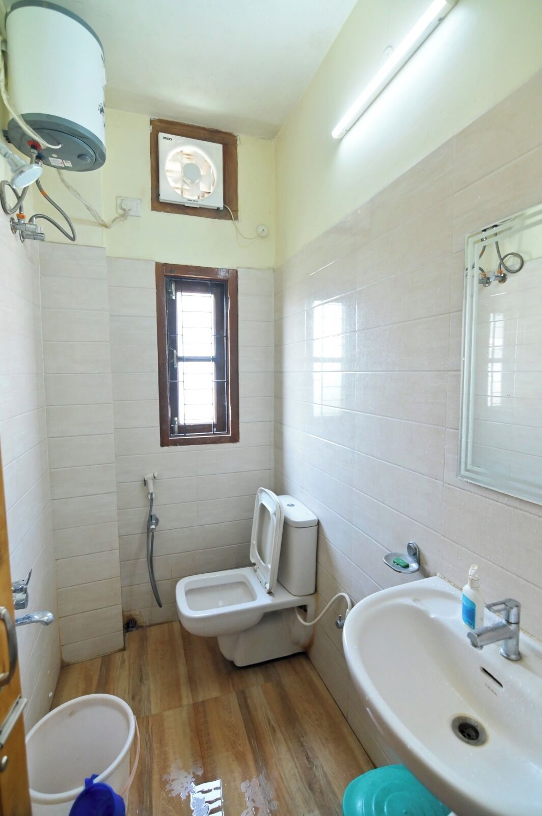 A bathroom with a toilet, sink, and shower.