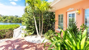 A beachfront property with a paved walkway leading to a building with a name sign. - Entire Resort, The Siesta Key Bungalows, 1-Mile to Turtle Beach (Siesta Key)