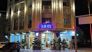 A multi-story hotel with a classic architectural design, featuring balconies and a prominent entrance. - Ha Anh Phan Thiet Hotel (Phu Thuy)
