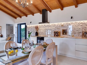 Enjoy cooking in this charming kitchen with a wine rack and dining area.