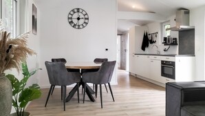 A modern kitchen with white cabinets, a built-in oven, and a black range hood. - Lovely home in Hellendoorn with WiFi (Hellendoorn)