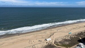 A beach with a sandy shore and a clear blue sky. - Oceanfront 3BR , Pool, 2 Balconies, Views by Karsons Keys (Ocean City)