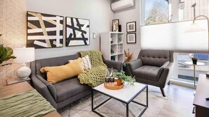 A modern living room with a grey sofa, a coffee table, and a bookshelf. - Newly Modern 2B2B Home near Seatac - Golf course (Seattle)